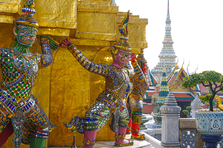 Gold plated, colourful statues on a temple in Bangkok