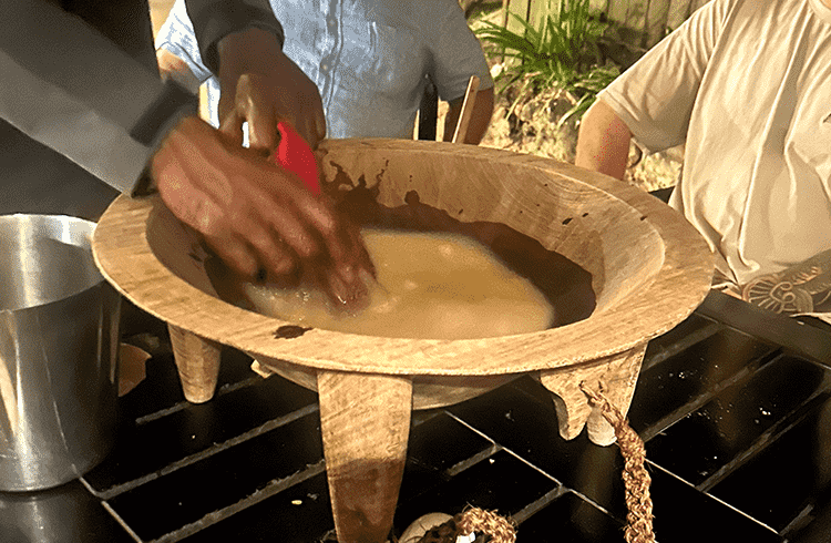 A man mixes kava during a ceremony in Fiji